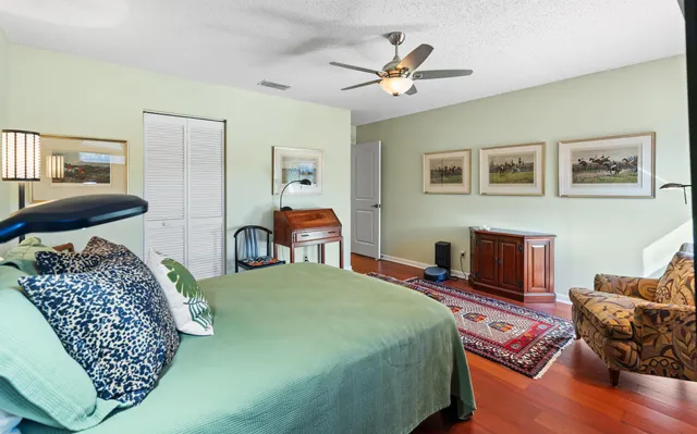 a bedroom with furniture and a wooden floor