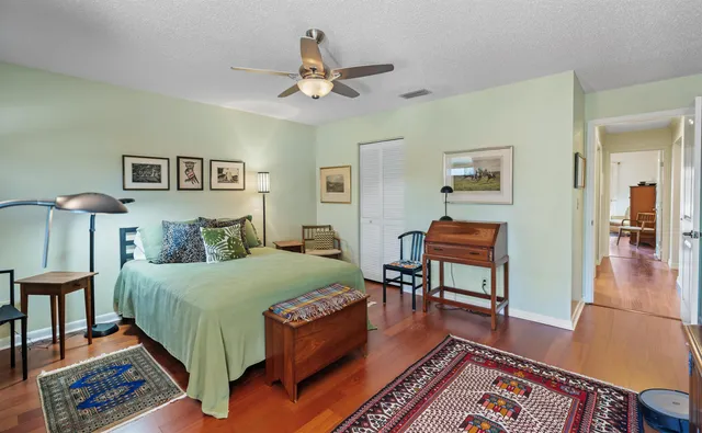a bedroom with a bed and wooden floor