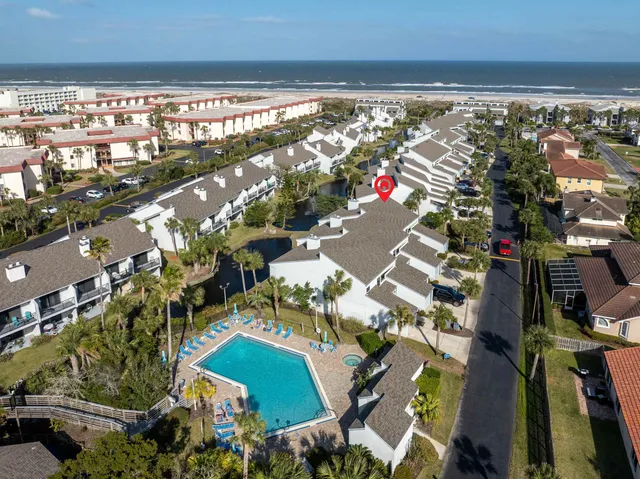 an aerial view of residential houses with outdoor space