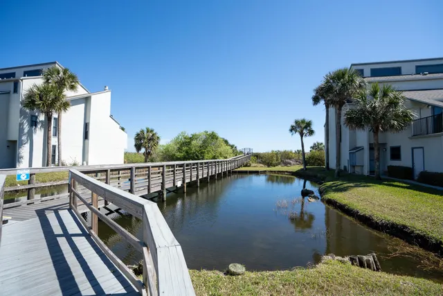 a view of a house with pool and outdoor seating