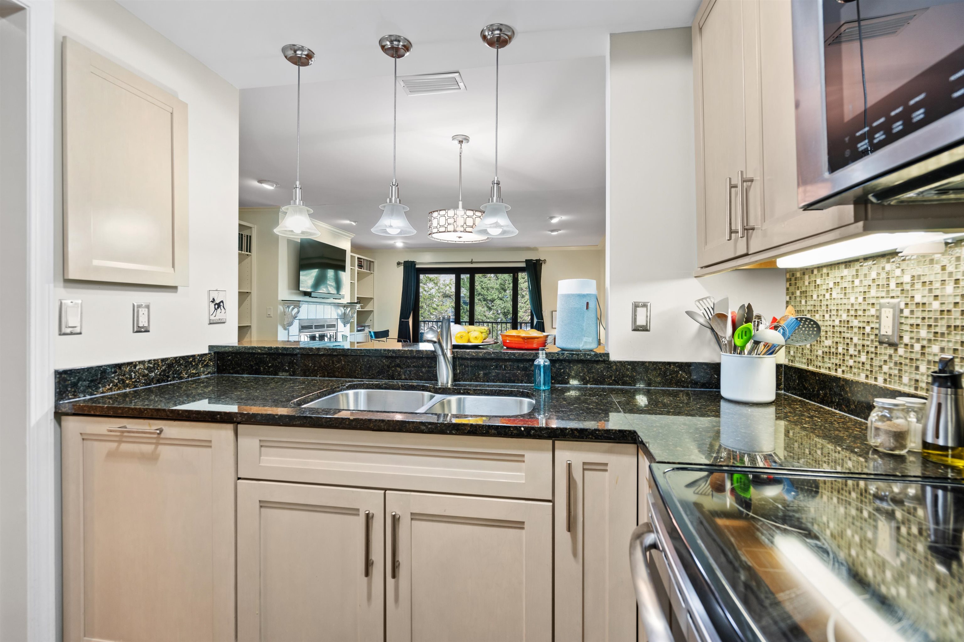 890 A1A Beach Boulevard, Unit 75 St. Augustine, FL 32080 - Photo 5 of 39 a kitchen with stainless steel appliances granite countertop a sink and cabinets