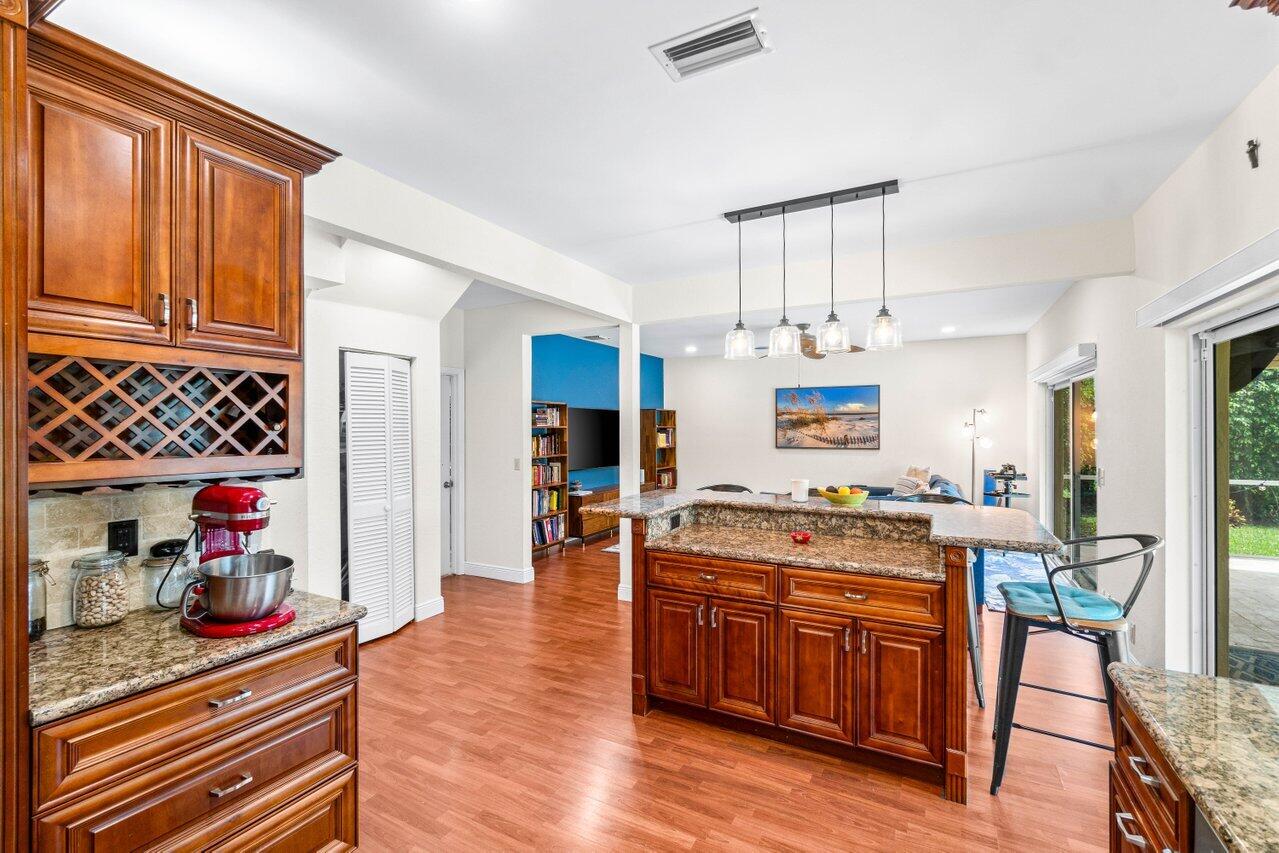 22145 Appleton Drive Boca Raton, FL 33428 - Photo 12 of 31 a open kitchen with stainless steel appliances granite countertop a stove and cabinets