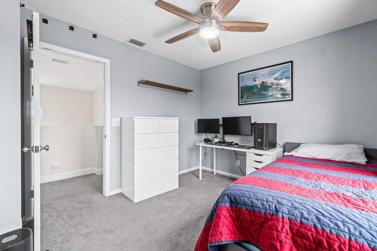 22145 Appleton Drive Boca Raton, FL 33428 - Photo 22 of 31 a bedroom with a bed and a flat screen tv