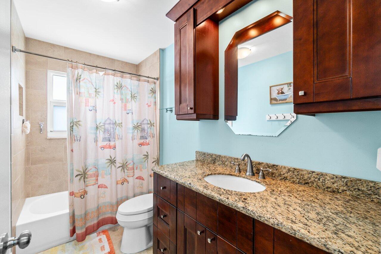 22145 Appleton Drive Boca Raton, FL 33428 - Photo 23 of 31 a bathroom with a granite countertop sink toilet and shower