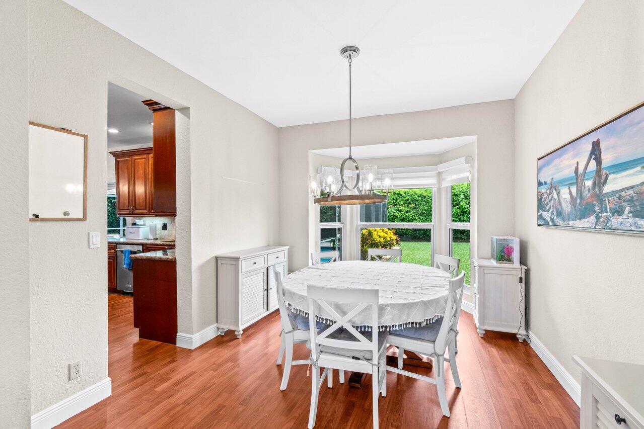 22145 Appleton Drive Boca Raton, FL 33428 - Photo 4 of 31 a view of a dining room with furniture large window and wooden floor