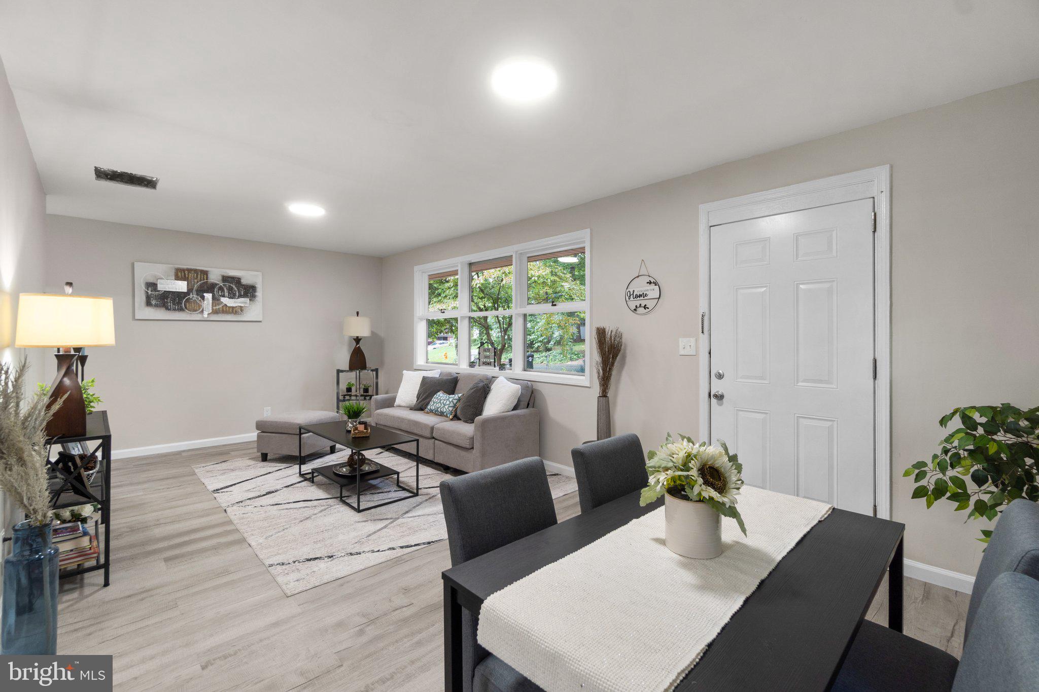 3648 Clifmar Road Windsor Mill, MD 21244 - Photo 5 of 22 a living room with furniture and a potted plant