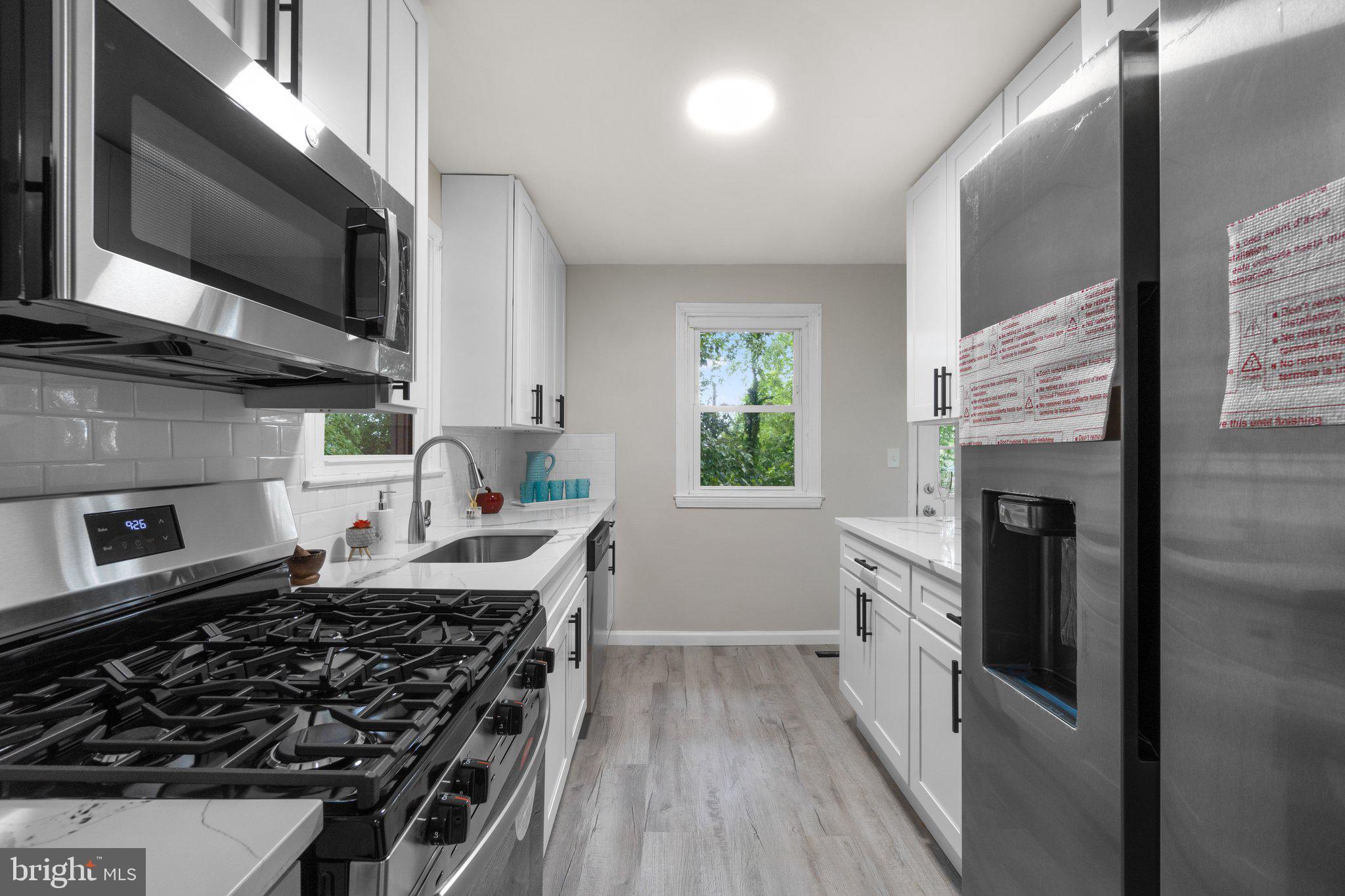 3648 Clifmar Road Windsor Mill, MD 21244 - Photo 6 of 22 a kitchen with stainless steel appliances a stove a sink and a microwave
