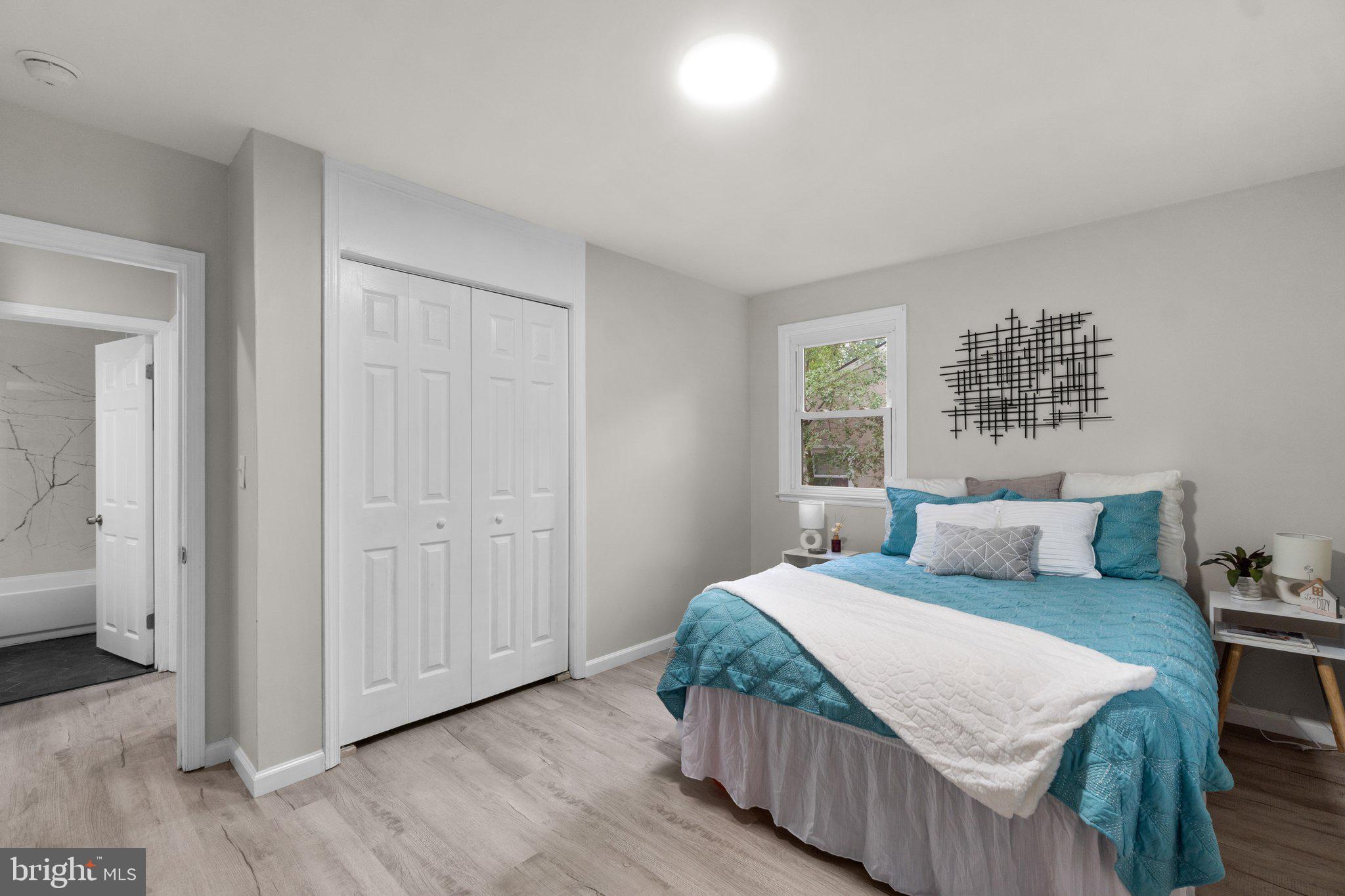 3648 Clifmar Road Windsor Mill, MD 21244 - Photo 10 of 22 a bedroom with a bed and wooden floor