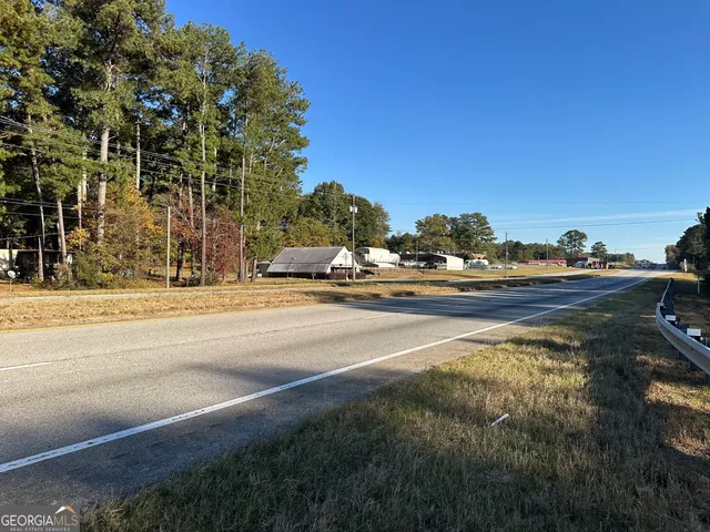 a view of a dry yard with trees