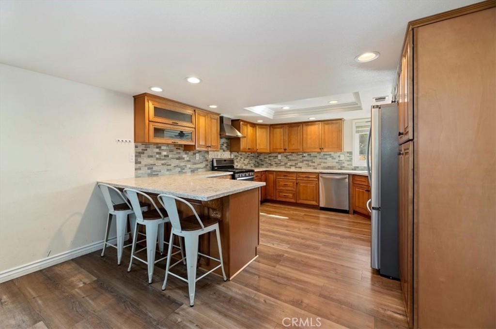 14231 Alexander Street Riverside, CA 92508 - Photo 11 of 36 a kitchen with a table and chairs in it