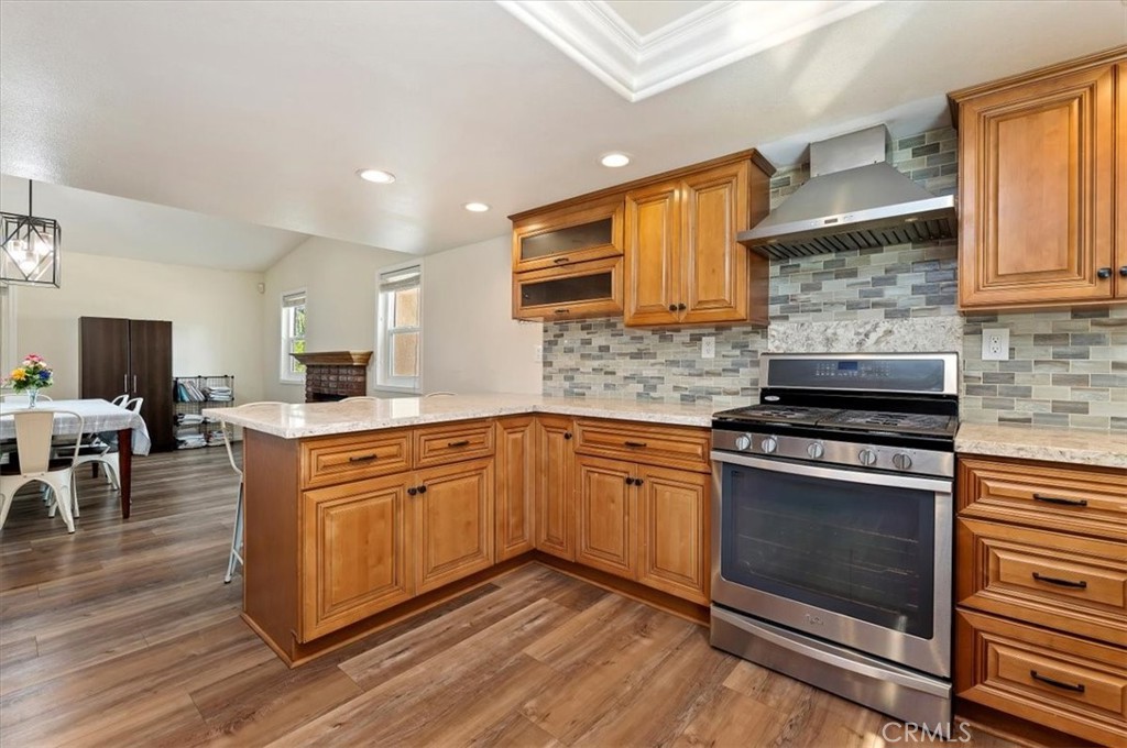 14231 Alexander Street Riverside, CA 92508 - Photo 14 of 36 a kitchen with stainless steel appliances granite countertop a stove a sink and a microwave