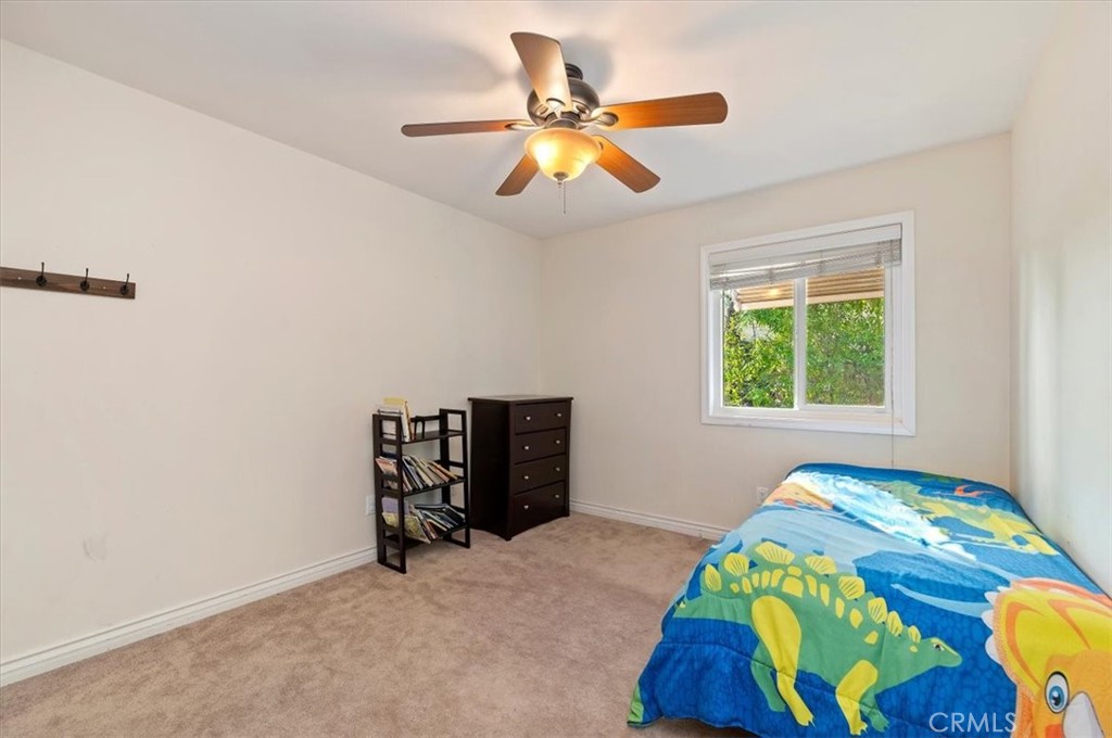 14231 Alexander Street Riverside, CA 92508 - Photo 20 of 36 a bedroom with a bed and a window