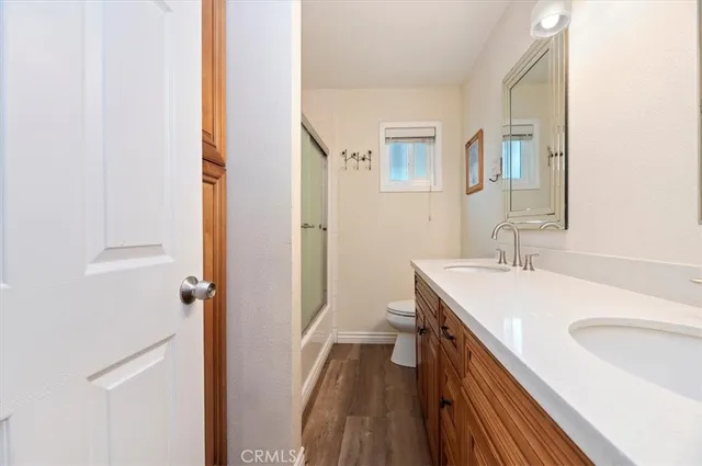 a bathroom with a sink a toilet and a mirror