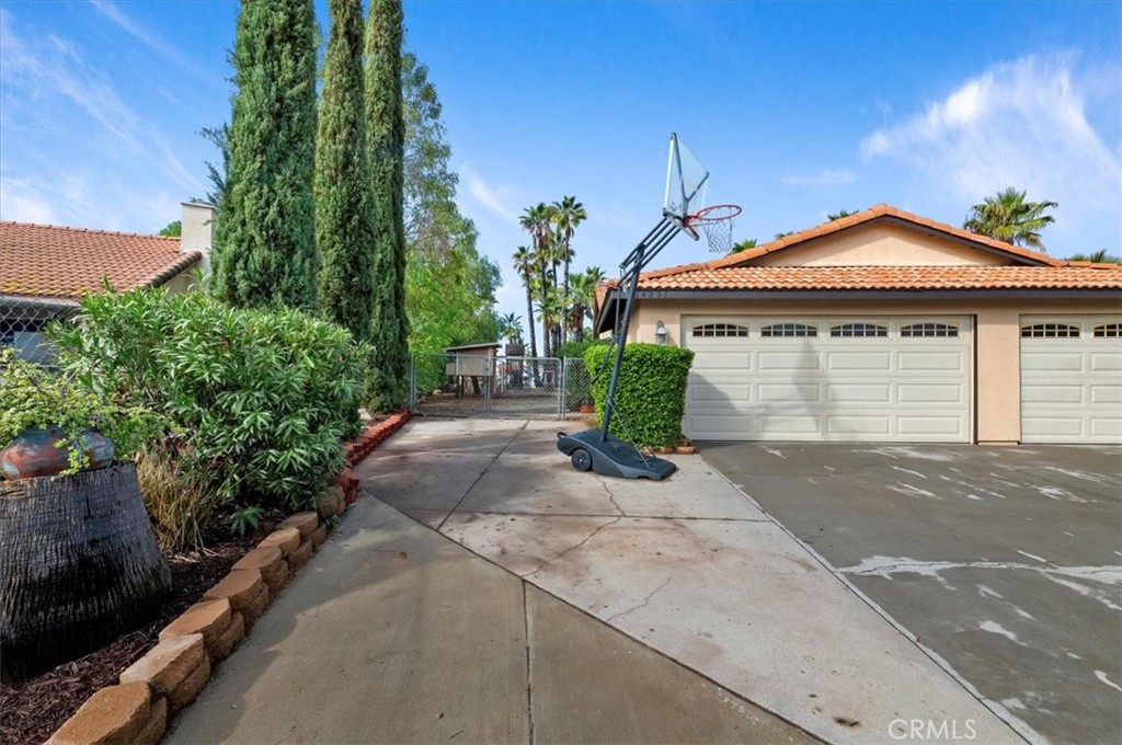 14231 Alexander Street Riverside, CA 92508 - Photo 4 of 36 a front view of a house with a yard and garage
