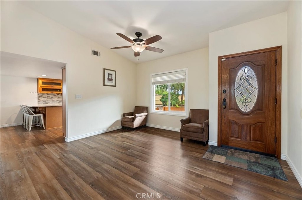 14231 Alexander Street Riverside, CA 92508 - Photo 6 of 36 a view of a livingroom with furniture a ceiling fan and wooden floor