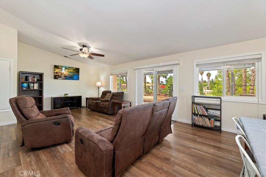 14231 Alexander Street Riverside, CA 92508 - Photo 9 of 36 a living room with furniture a flat screen tv and wooden floor