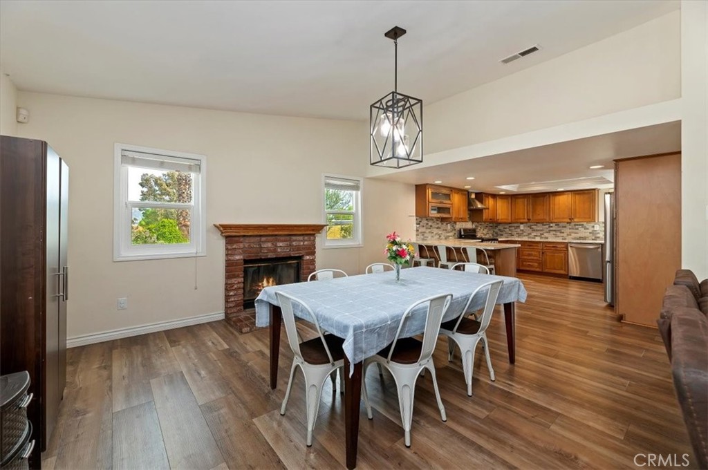 14231 Alexander Street Riverside, CA 92508 - Photo 10 of 36 a view of a dining room with furniture a chandelier and wooden floor