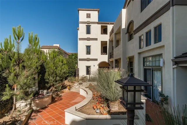 a view of a patio with table and chairs barbeque oven and potted plants