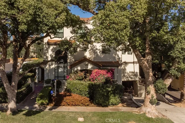 a view of a house with a yard and sitting area