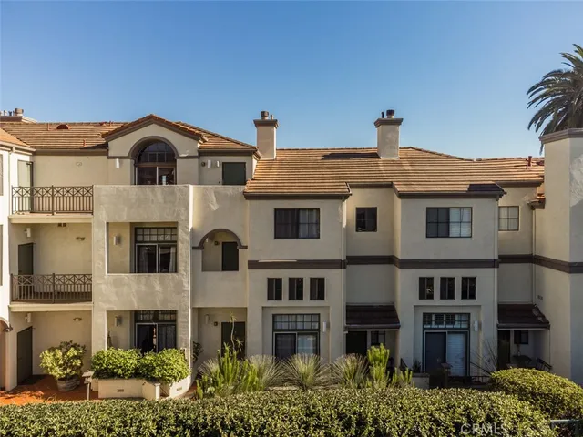 a front view of a residential apartment building with a yard