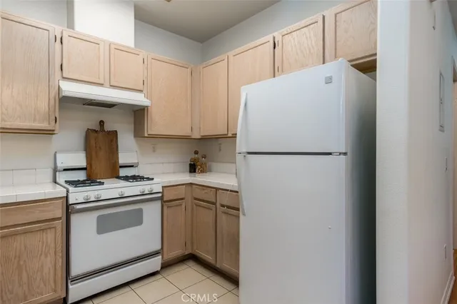 a white refrigerator freezer sitting inside of a kitchen