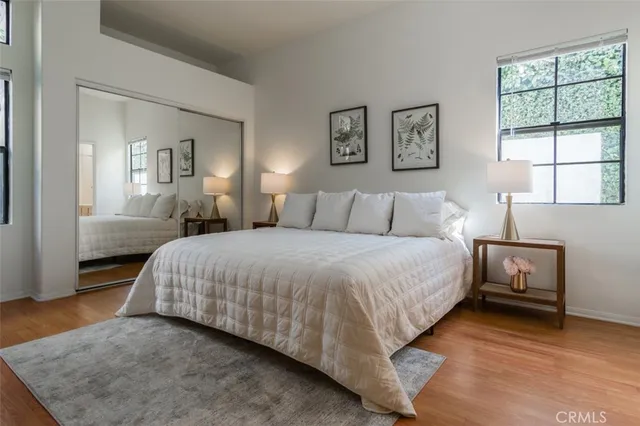 a bedroom with a bed and a night stand