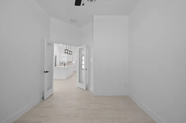 a view of a hallway with white walls