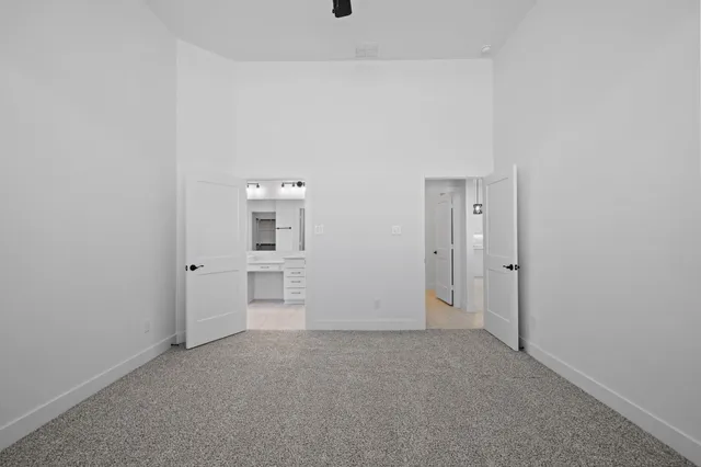 a bathroom with a tub a sink double vanity and a mirror