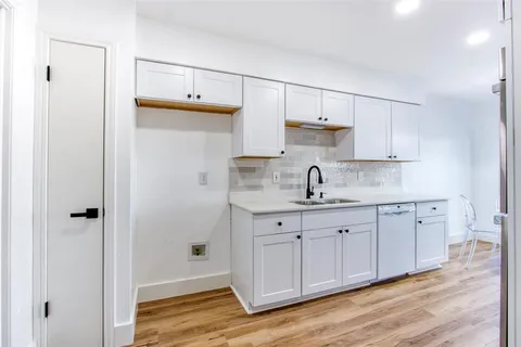 a kitchen with cabinets a sink and appliances