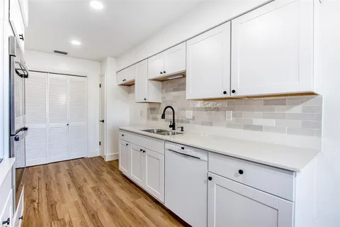 a kitchen with a sink and cabinets