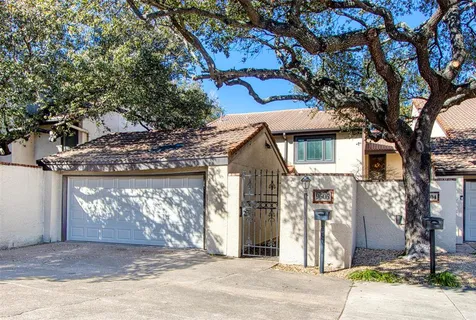 a view of a house with a tree