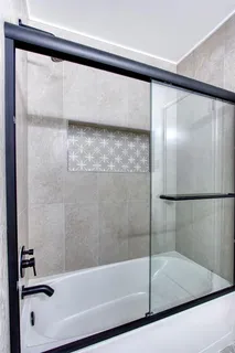 a bathroom with a bathtub and a shower