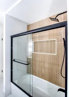 a bathroom with a shower and a bath tub