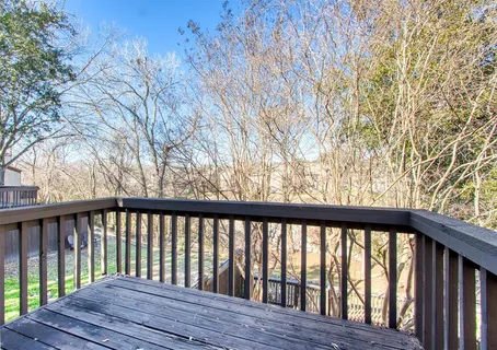 a view of wooden balcony and trees