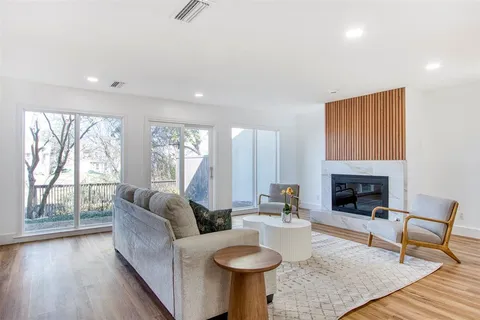 a living room with fireplace furniture and a fireplace