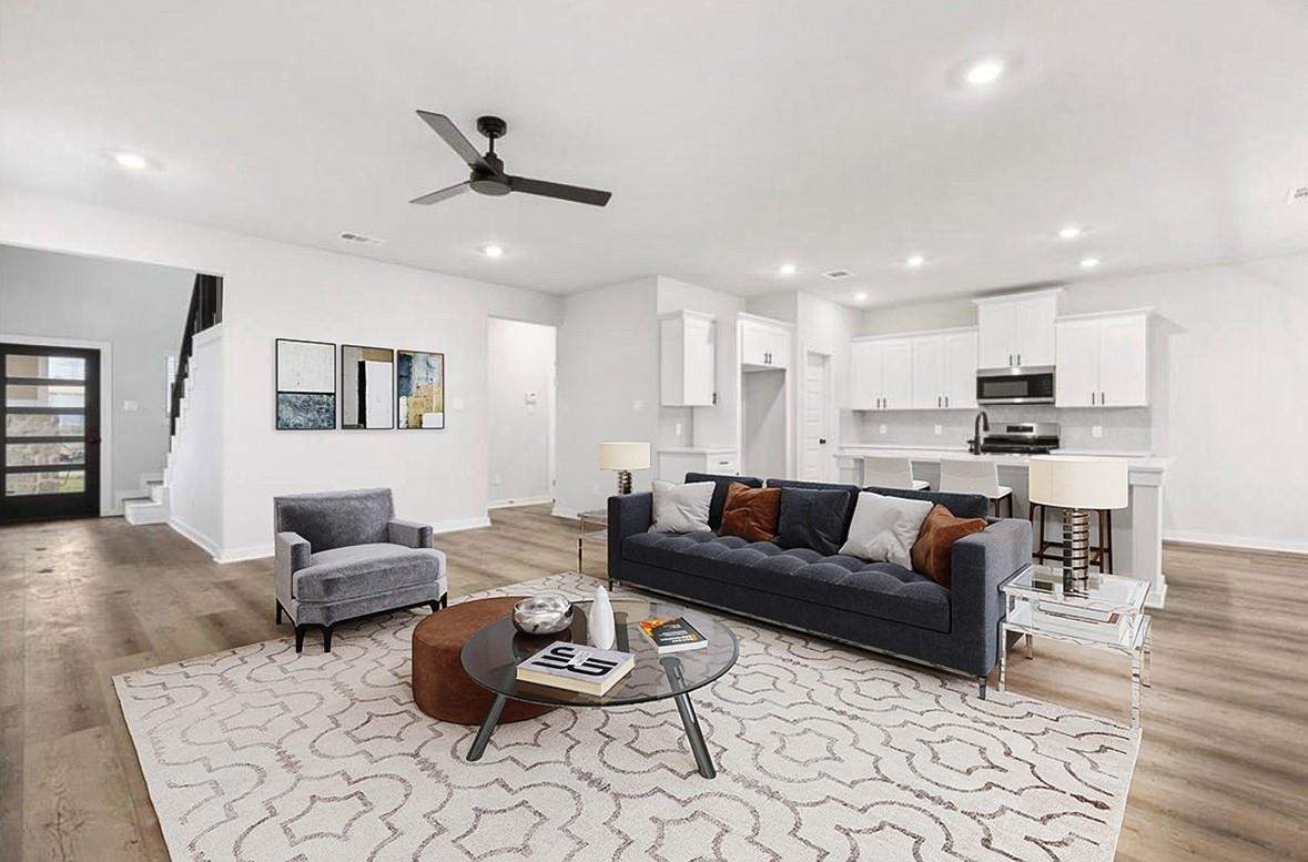 a living room with furniture and kitchen view