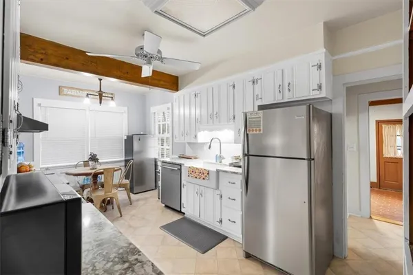 a kitchen with refrigerator and cabinets