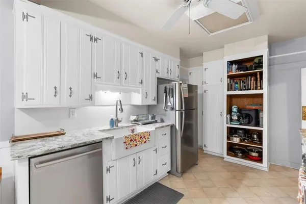 a kitchen with stainless steel appliances granite countertop a refrigerator and a stove