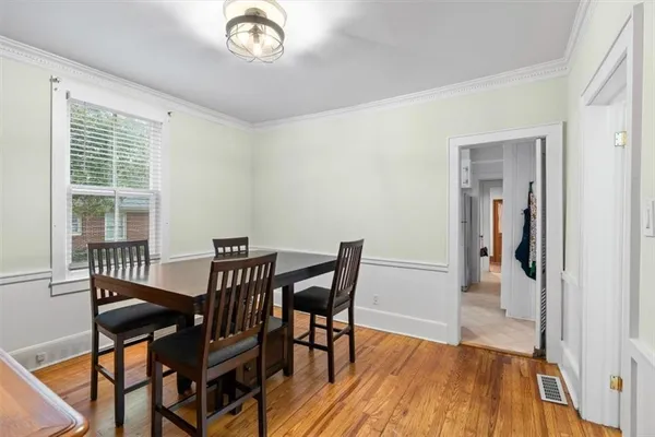 a view of a dining room with furniture and wooden floor
