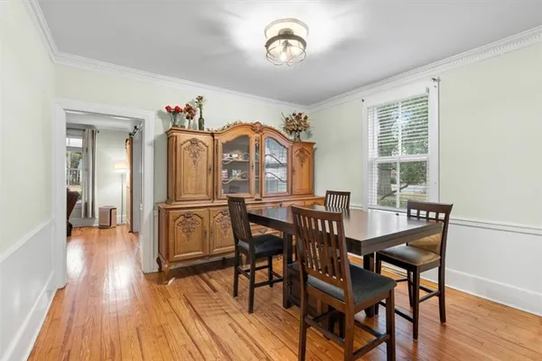 a view of a dining room with furniture window and wooden floor
