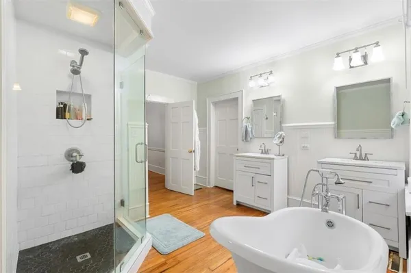 a spacious bathroom with a sink double vanity and a shower