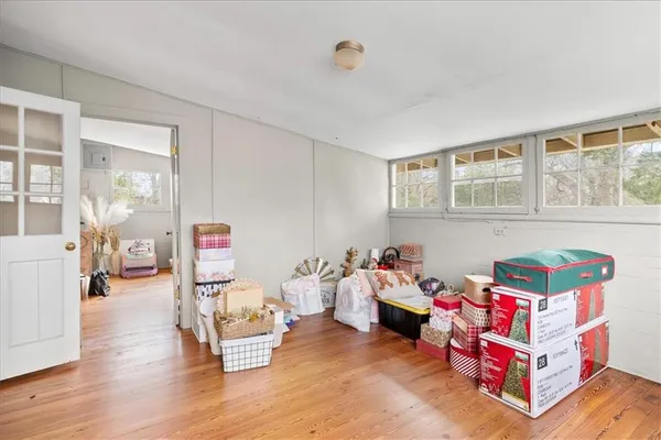 a bedroom with a bed and a potted plant