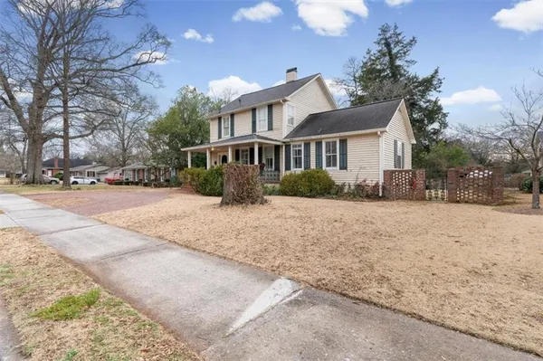 a front view of house with yard and trees around