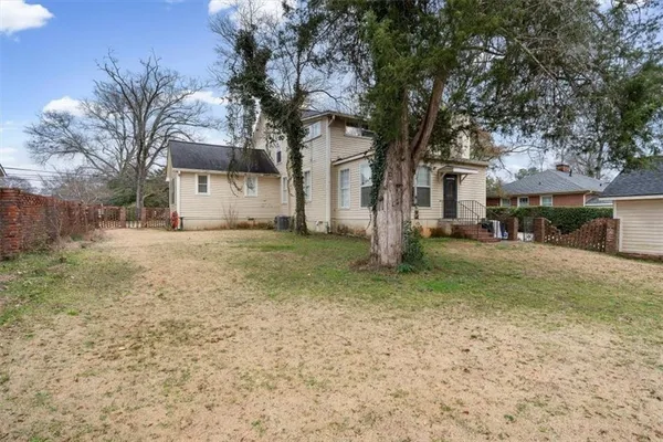 an aerial view of a house with a yard