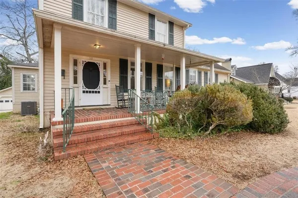 a view of a house with backyard and sitting area