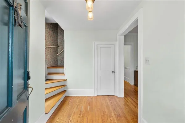 a view of entryway with stairs and wooden floor