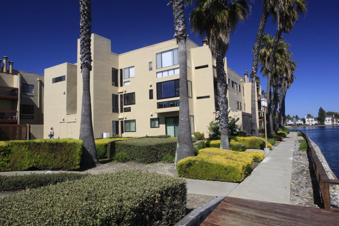 914 Beach Park Boulevard, Unit 77 Foster City, CA 94404 - Photo 1 of 1 a front view of a house with a yard and potted plants