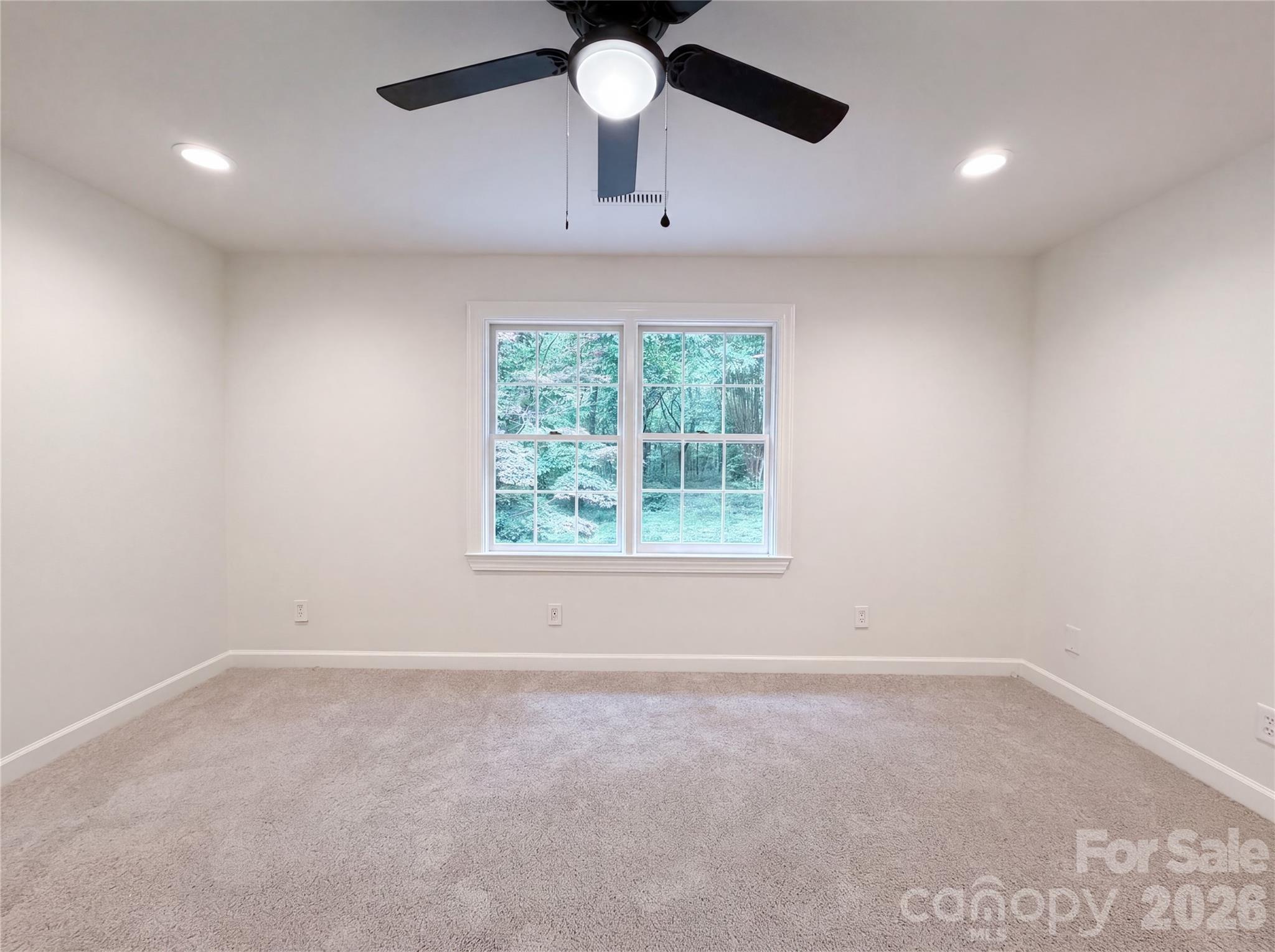 318 Valley Stream Road Statesville, NC 28677 - Photo 13 of 21 an empty room with ceiling fan and windows