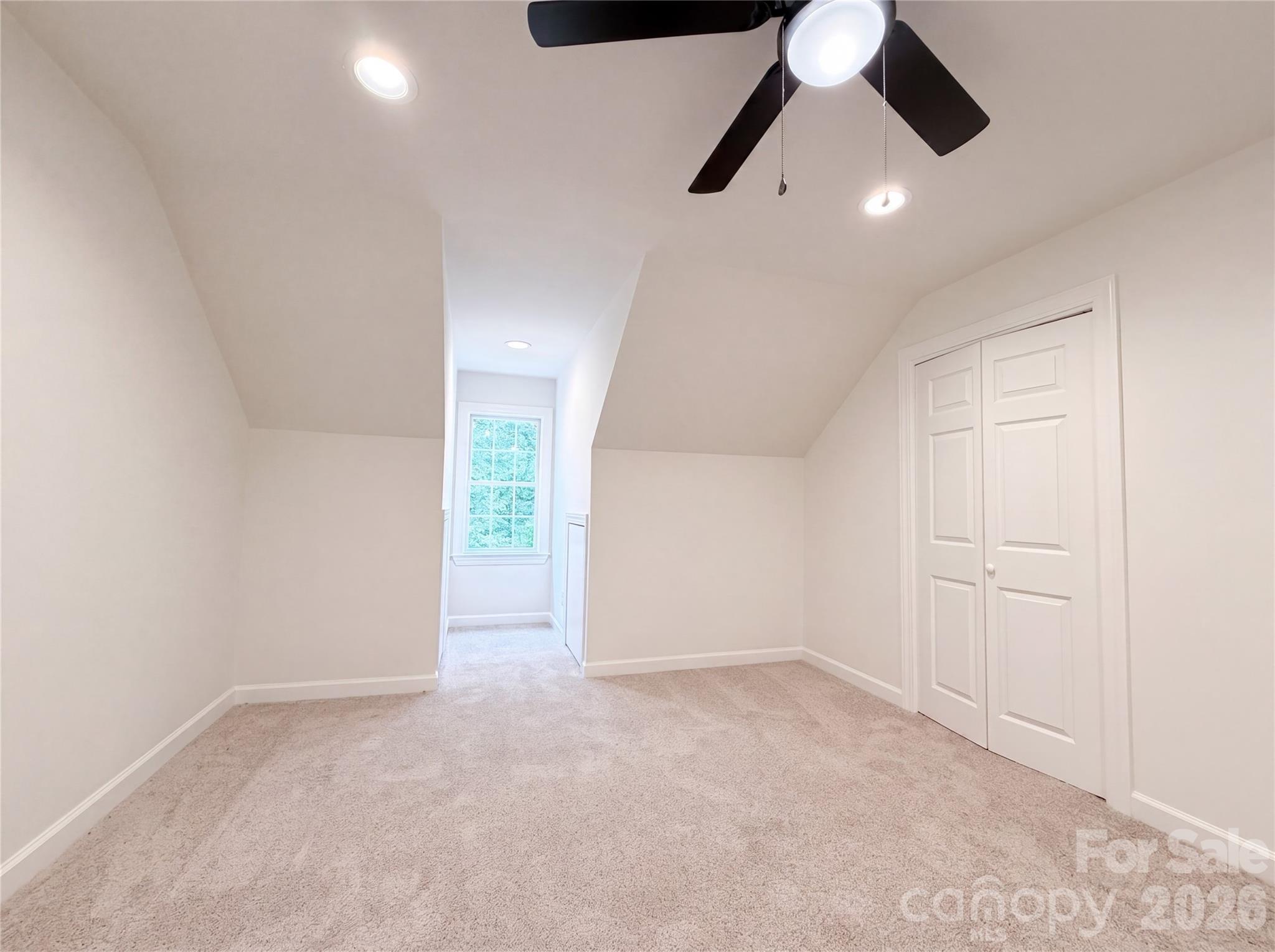 318 Valley Stream Road Statesville, NC 28677 - Photo 15 of 21 an empty room with ceiling fan and window
