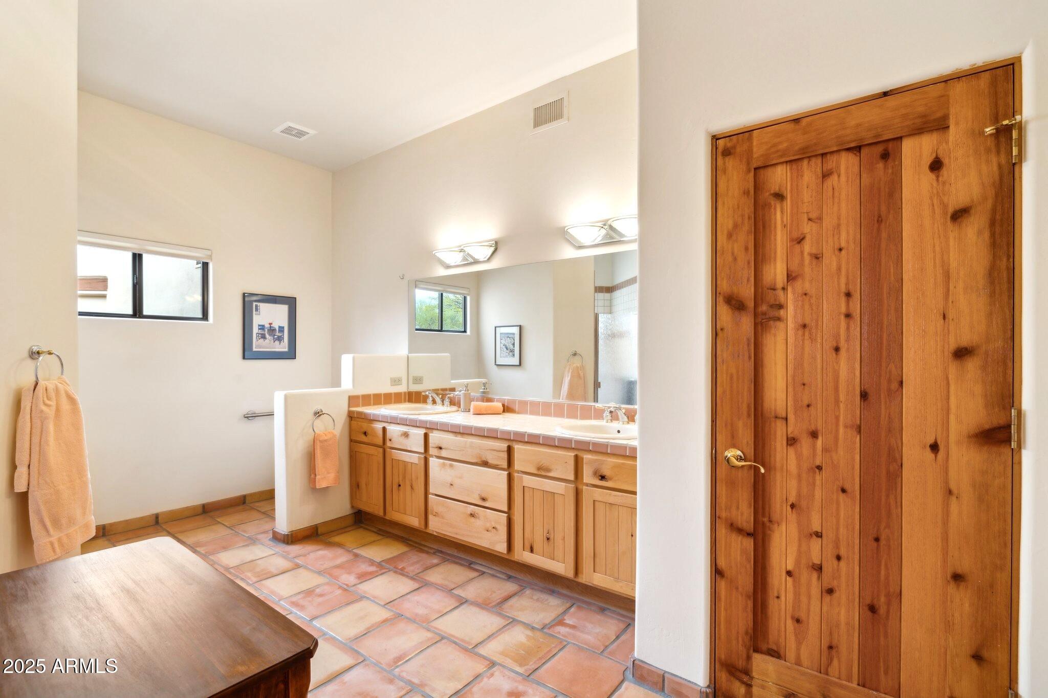 30600 North Pima Road, Unit 38 Scottsdale, AZ 85266 - Photo 36 of 49 a large bathroom with a double vanity sink a mirror and a bathtub